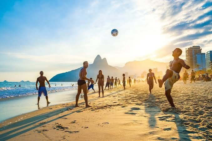 Beach football at sunset